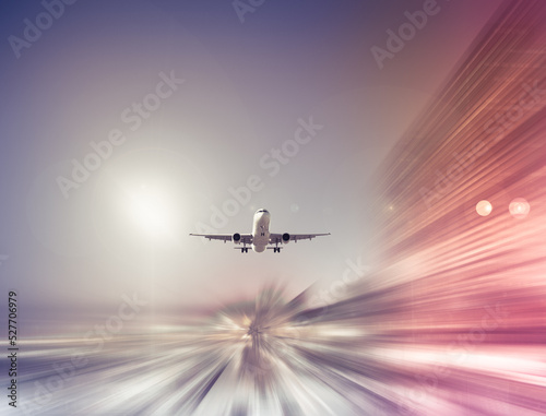 Big airplane taking up motion in sky on landscape blurred background
