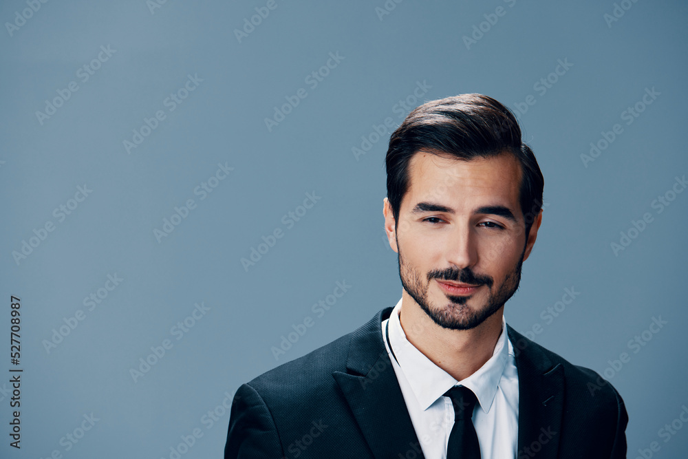 Portrait of business man with phone conversation and on blue background in business suit. Business portrait of a stylish man copy space Portrait of business man with phone conversation and on blue background in business suit. Business portrait of a stylish man copy space