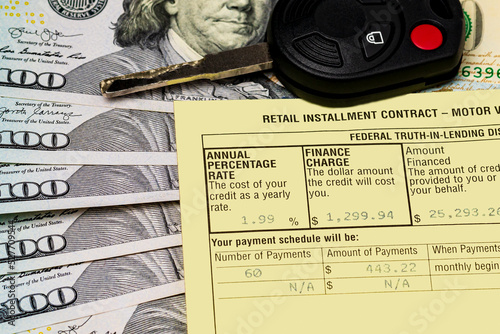 Auto loan contract, car key and cash money. Interest rate, credit and debt concept. photo