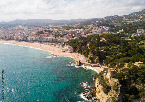View from drone of Spanish town of Lloret de Mar on Mediterranean coast in summer day.