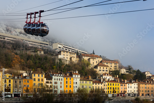 Image of cable cars in Grenoble in autumn over riverside, France.