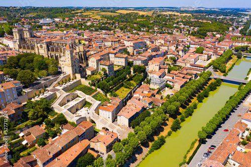 Picturesque summer landscape of French city of Auch on bank of River Gers overlooking Roman Catholic Cathedral and Armagnac Tower..