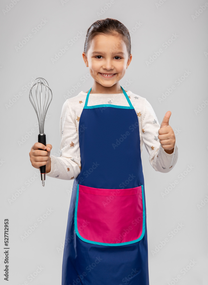 cooking, culinary and profession concept - happy smiling little girl in apron holding whisk showing thumbs up over grey background cooking, culinary and profession concept - happy smiling little girl in apron holding whisk showing thumbs up over grey background