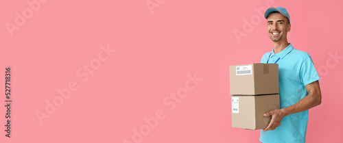 Delivery man with parcels on pink background with space for text