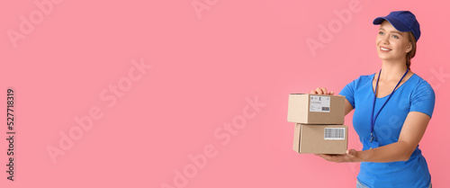 Female courier with parcels on pink background with space for text