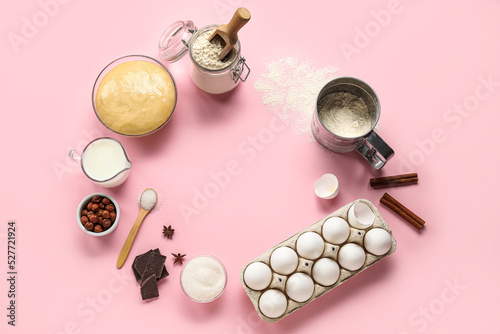 Frame made of ingredients for baking on pink background