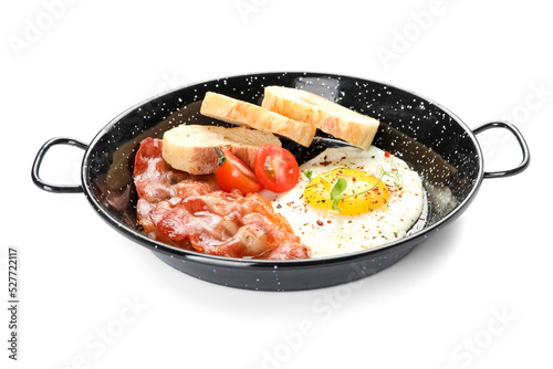 Frying pan with tasty fried egg, bacon and bread on white background