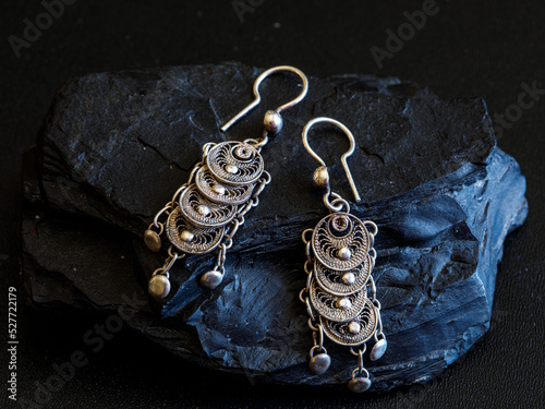 traditional authentic Lefkara filigree silver ear rings on black background. Cyprus vintage jewelry. photo