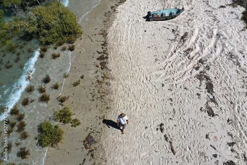 Aerial landscape view of Australian man walking on empty wild beach