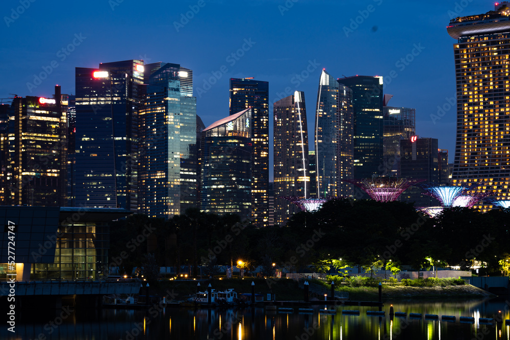 Singapore city skyline with modern skyscraper architecture building for concept of financial business and travel in Asia cityscape urban landmark, marina bay at night district dusk sky