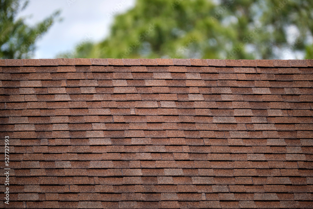 Closeup of house roof top covered with asphalt or bitumen shingles. Waterproofing of new building Closeup of house roof top covered with asphalt or bitumen shingles. Waterproofing of new building