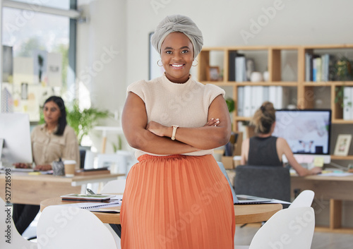 Innovation, leadership and a proud black business woman standing in power in a corporate office. Happy African American leader excited by successful goal management with diverse female employees photo