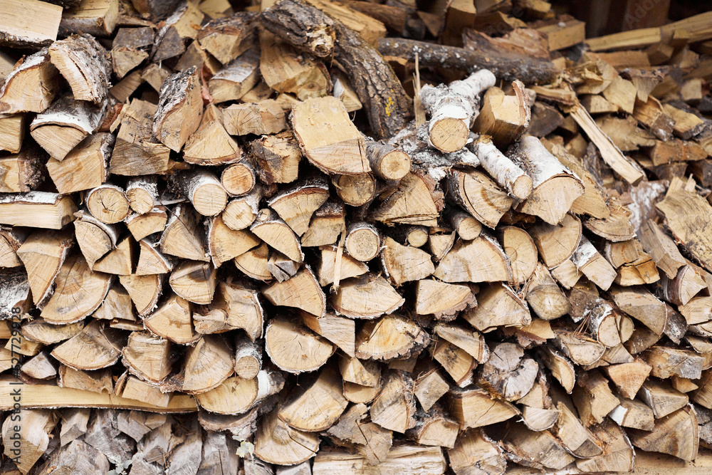 A woodpile of birch firewood stacked on top of each other. Front view. A woodpile of birch firewood stacked on top of each other. Front view.