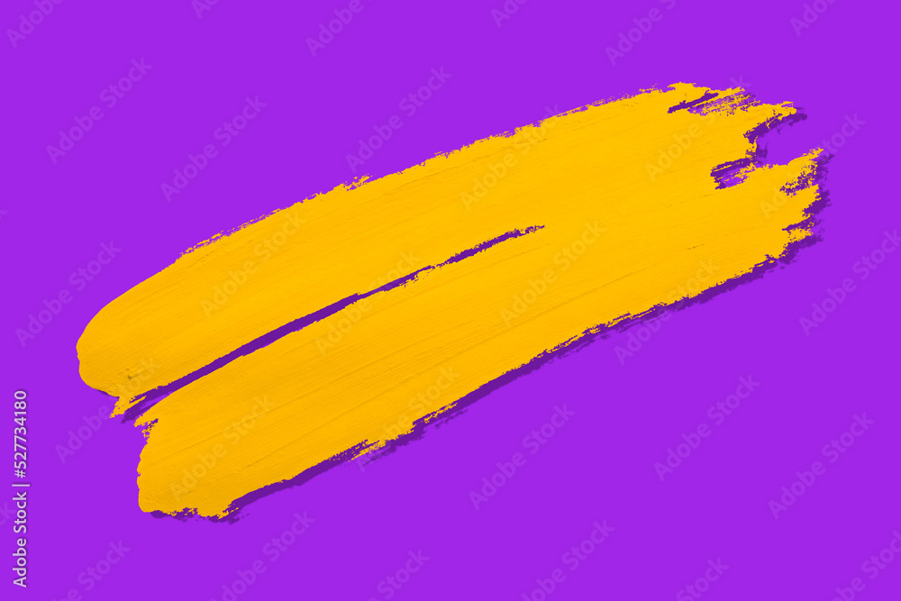 Fototapeta premium yellow brush and shadow isolated on a purple background