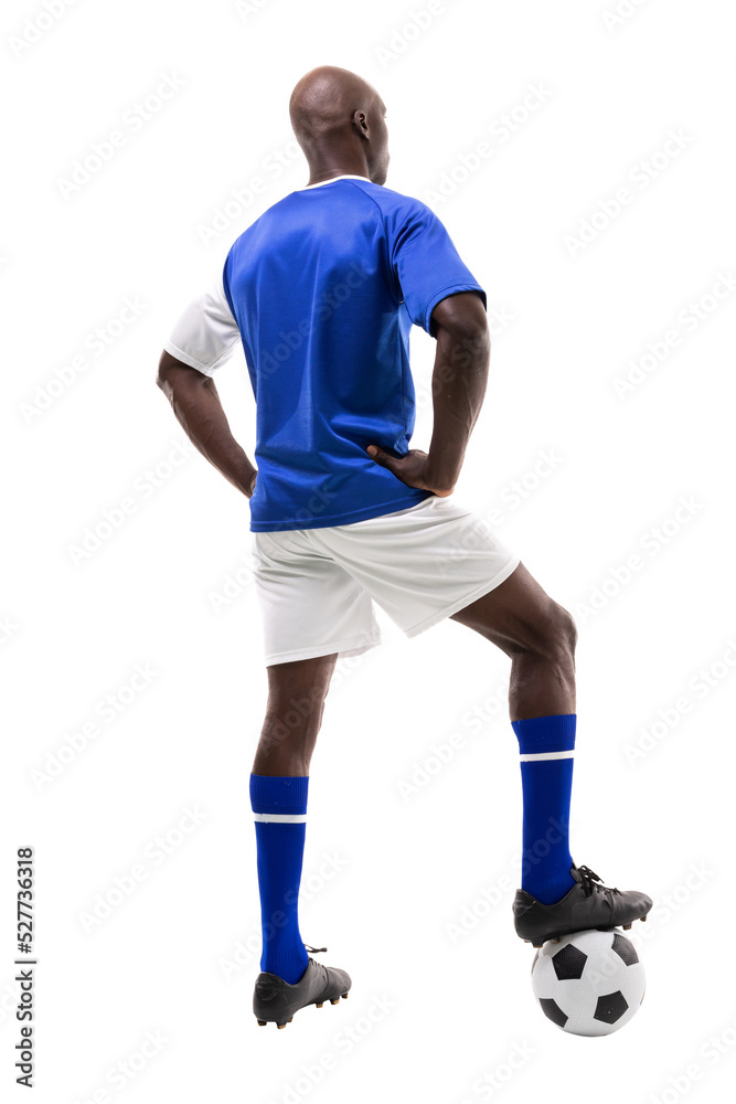 Rear view of young male african american soccer player stepping on ball over white background Rear view of young male african american soccer player stepping on ball over white background