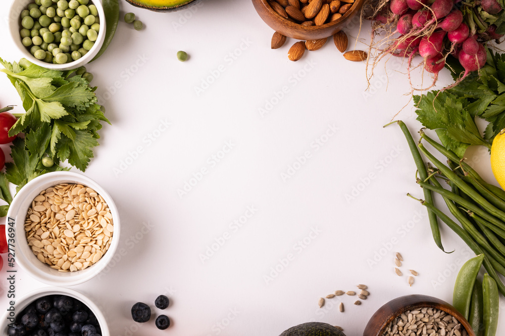 Directly above view of copy space amidst various fresh food on white background Directly above view of copy space amidst various fresh food on white background