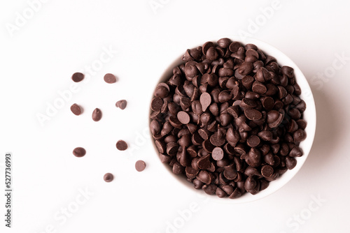 Directly above view of fresh chocolate chips in bowl over white background photo