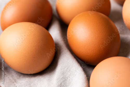 High angle close-up of fresh brown eggs on gray napkin