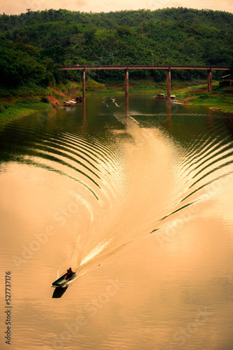 Boat sailing in the river in thailand photo