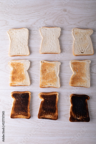 Close-up of toasted and burnt bread slices arranged on table