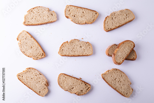 Directly above shot of bread slices arranged on white background