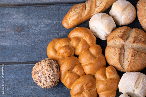 Close up view of different types of breads with copy space on blue wooden surface