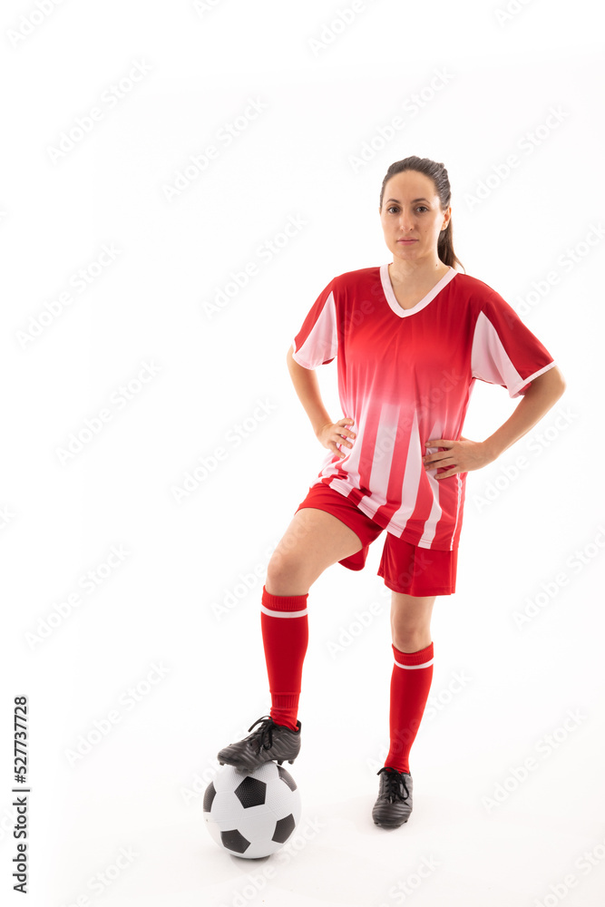 Portrait of caucasian young female player with hand on hip and standing with foot on soccer ball Portrait of caucasian young female player with hand on hip and standing with foot on soccer ball