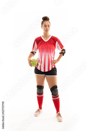 Full length of biracial young female player with handball standing against white background © wavebreak3