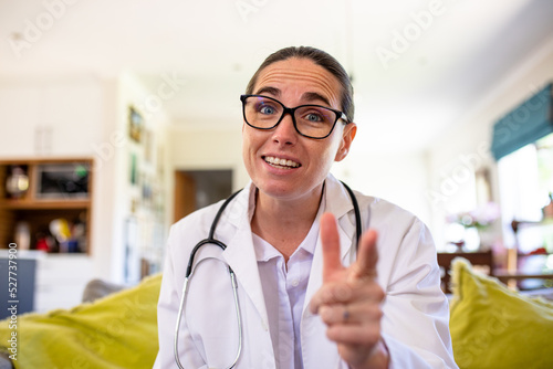 Mature caucasian female doctor gesturing while explaining on video call, copy space