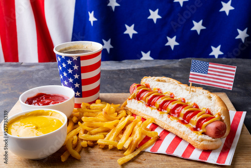 High angle view of hot dog meal with american flag served on serving board at table