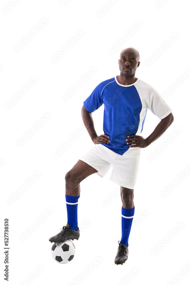 Portrait of confident male african american athlete stepping on soccer ball against white background