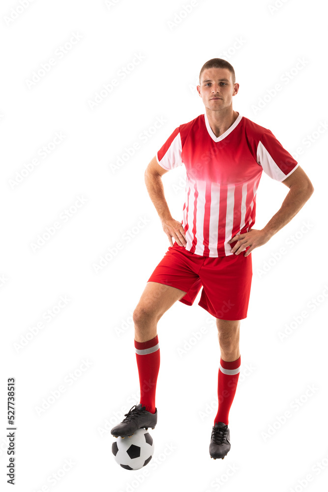 Full length of confident young male caucasian athlete stepping on soccer ball over white background