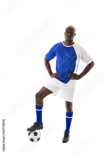 Portrait of confident male african american athlete stepping on soccer ball against white background © wavebreak3