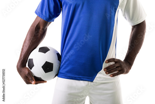 Midsection of young male soccer player holding ball standing against white background