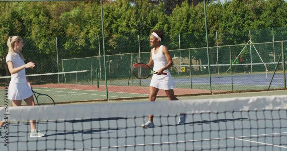 Video of happy diverse female tennis players holding rackets and clapping hands Video of happy diverse female tennis players holding rackets and clapping hands