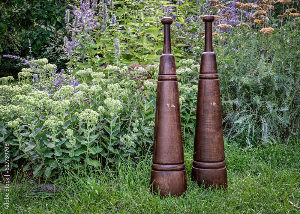 A couple of traditional wooden Persian meels in a backyard. They originated in Persia (now Iran), as a key strength building exercise. A couple of traditional wooden Persian meels in a backyard. They originated in Persia (now Iran), as a key strength building exercise.