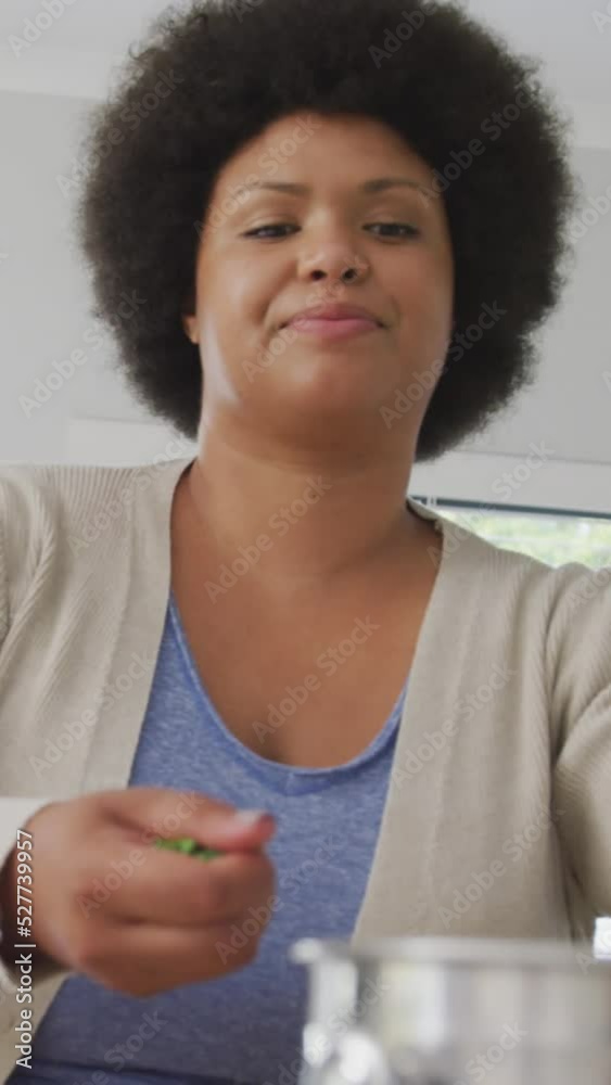Video of happy plus size african american woman preparing meal Video of happy plus size african american woman preparing meal
