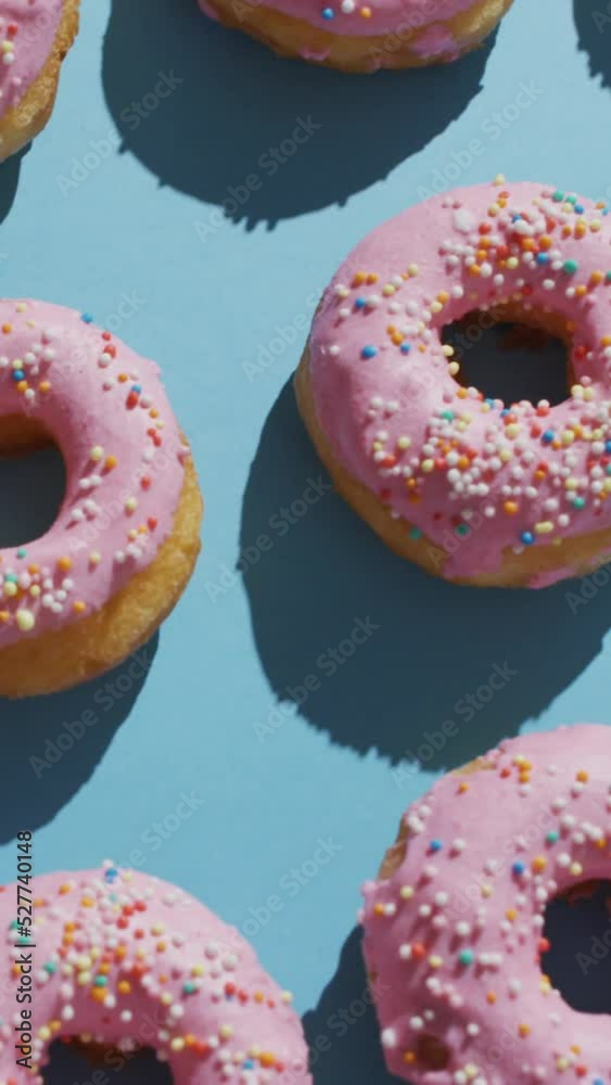Video of donuts with icing on blue background