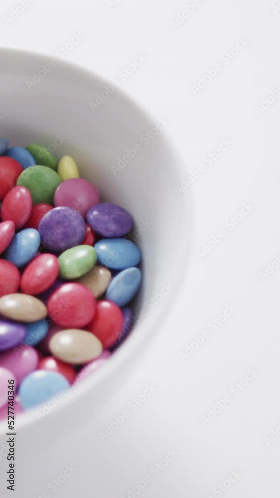 Video of multicolored lentils in bowl on white background