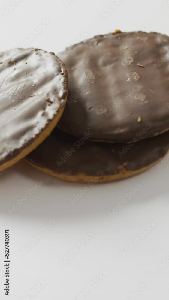 Video of three chocolate coated biscuits on white background with copy space Video of three chocolate coated biscuits on white background with copy space