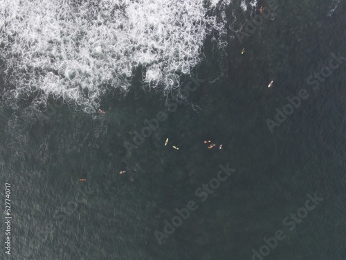 Photography Aerial view of people surfing on waves with surfboards when vacation in Bali, In