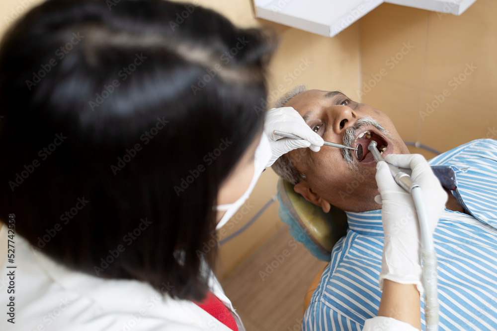 Dentist doing dental treatment in clinic Dentist doing dental treatment in clinic