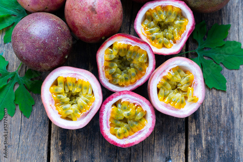 Passion fruit   Maracuya   with Passion fruit cut in half slice on wooden table background .