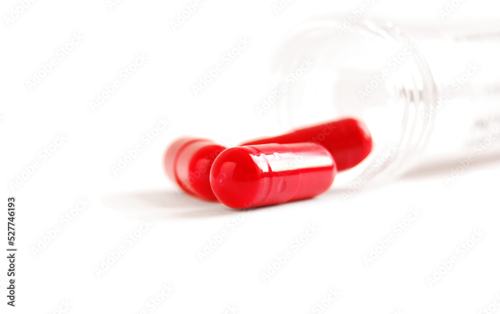 A group of red capsules from bottle isolated on white background
A group of red capsules from bottle isolated on white background