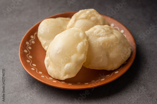 Luchi or Lusi is a deep-fried poori or flatbread, made of Maida flour, originating from Bengal photo