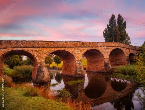 sunrise over historic stone bridge