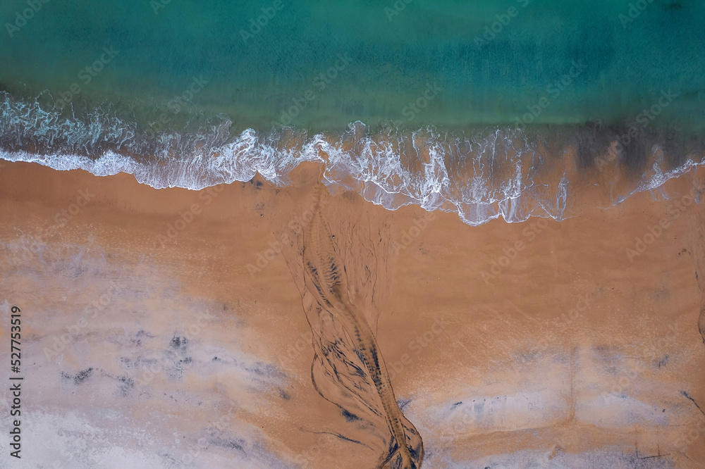 Aerial top down view on a beautiful beach and ocean surface with blue water. Keem bay, Ireland. Nature scene.