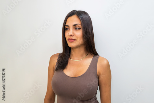 Photography Close-up of a beautiful sexy brunette with a big bust on a white background