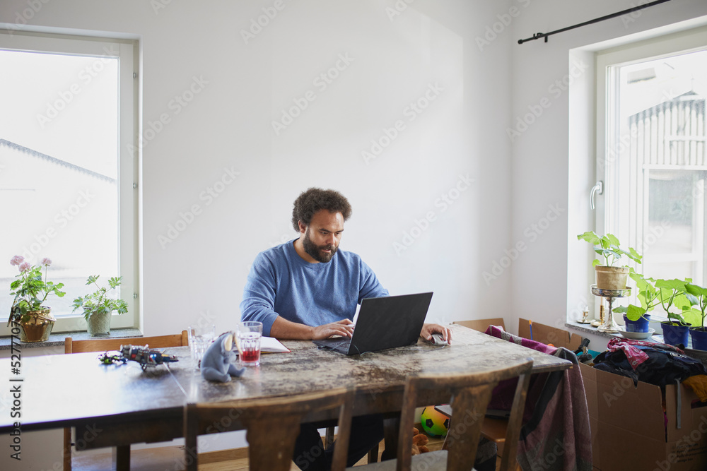 Man working on laptop from home Man working on laptop from home