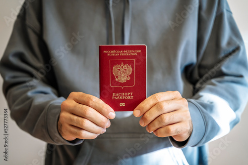 Russian passport in the hands of a man. Prohibition of Schengen visas for Russian tourists to travel to the European Union concept.